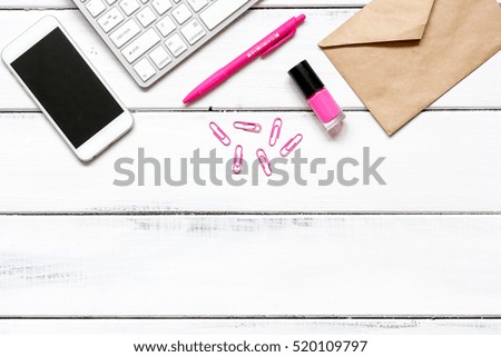 female wooden desktop with smartphone, paper envelopes top view