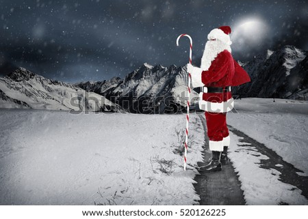 Santa claus on road and winter christmas night 