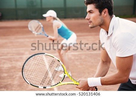 Side view of tennis man and woman. woman on background