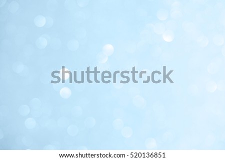 Unfocused abstract light blue glitter bokeh holiday background. Winter xmas holidays. Christmas.