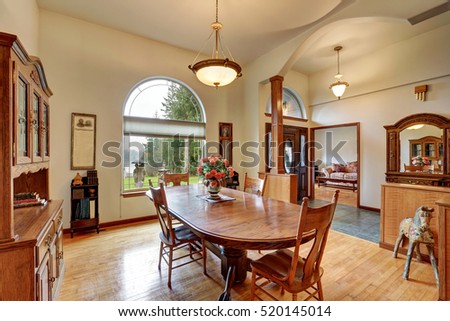  Bright dining room with high ceiling and arched window with lake view. Northwest, USA
