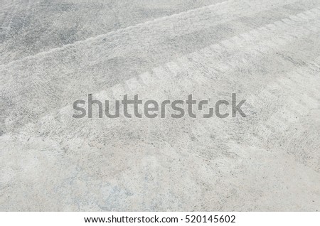 Closeup surface concrete floor with tire tracks textured background
