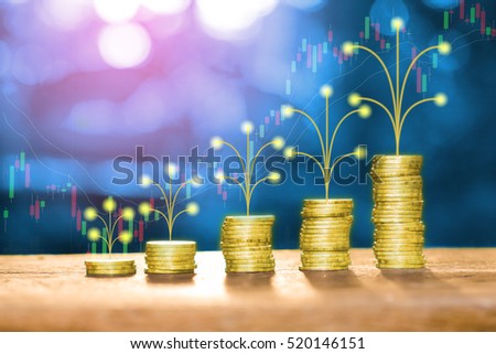 Golden money pile coins on wood table with artificial tree growth concept