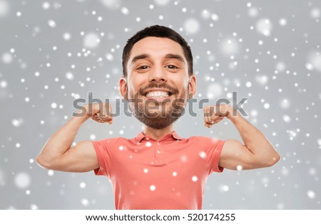 fitness, strength, sport, winter and people concept - happy smiling young man showing biceps power(funny cartoon style character with big head) over snow on gray background