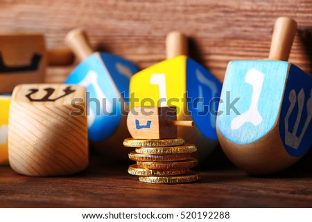 Dreidels for Hanukkah on wooden table, close up