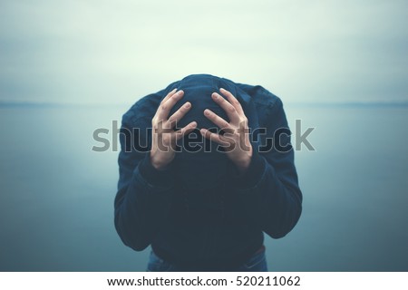 desperate man holding head with hands Royalty-Free Stock Photo #520211062