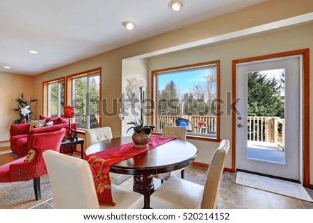 Open concept dining room with round solid wood table and white leather chairs. Northwest, USA