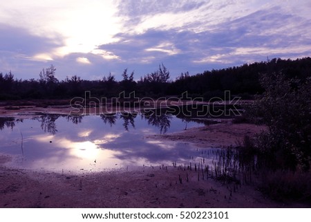 Mirror of purple sky in the morning reflection to the water,Thailand.
