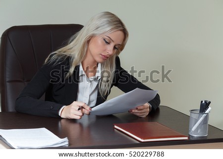 beautiful businesswoman working at her office desk with documents