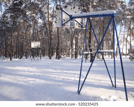 Basketball playground covered with snow