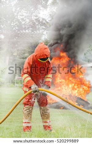 Firefighter with blurry fire background