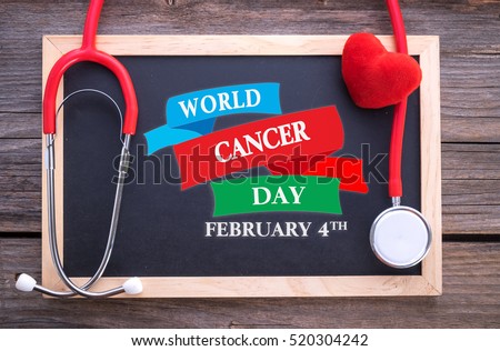 World Cancer Day, February 4th on chalkboard, stethoscope and red heart, health concepts. 