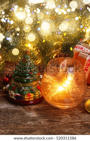 Christmas magic glowing light with evergreen tree on wooden background, low key with bokeh lights