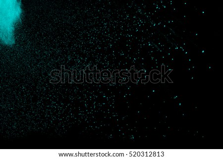 Freeze motion of powder coming down, isolated on black, dark background. Abstract design of falling dust cloud.Particles cloud screen saver, wallpaper with copy space. Rain, snow fall concept