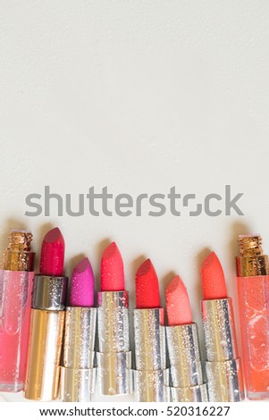 Set of wet lipsticks with copy space on beige deskop border with copy space