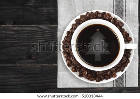 top view christmas tree reflective light on hot black coffee with beans in white cup on plate mat or tablecloth top side and vintage black wood table with copy space for your text or object