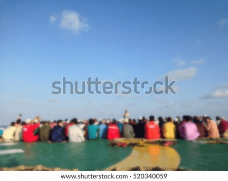 Offshore workers gathered on helideck for Muslim prayer in motion blur. Welcome Eid's Feast.