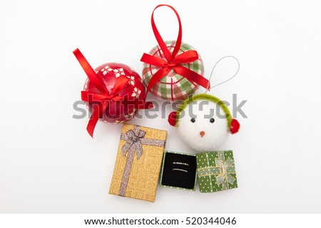 ring in christmas gift box and decoration ball of christmas tree on white backgrounds