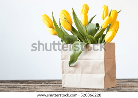 Valentines Day background with hearts and yellow tulips on wooden table