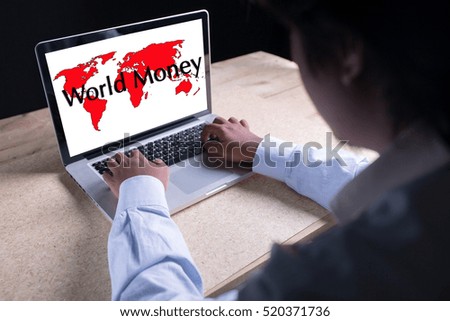 World Money writing on laptop with world map background with businessman hand working
