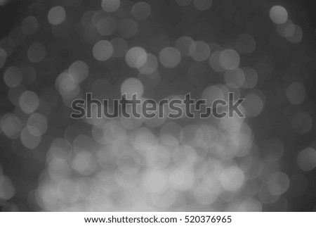white bokeh lights on black background