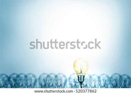 Outstanding creative idea background concept . one Light bulb glowing among a group light bulbs. Royalty-Free Stock Photo #520377862