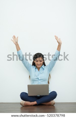 Joyful Young Woman Working on Laptop on Floor