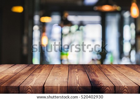 wood table on blur of cafe, coffee shop, bar, background - can used for display or montage your products Royalty-Free Stock Photo #520402930