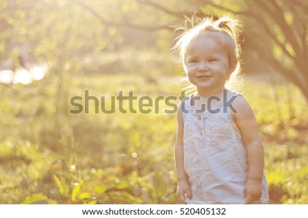 
Portrait of a cute girl in a summer park in the sun