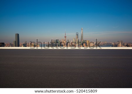 Empty road floor surface with modern city landmark buildings of Shanghai bund Skyline 