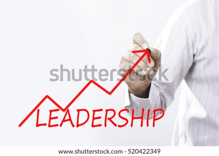 Businessman writing leadership with red growth arrow. Leadership concept