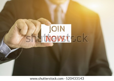 Man's hand holding card with JOIN NOW message,,selective focus,vintage color

