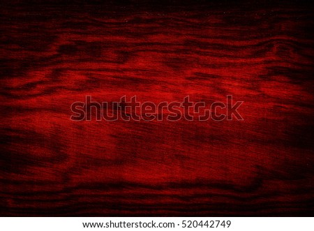 Dark red wooden background.