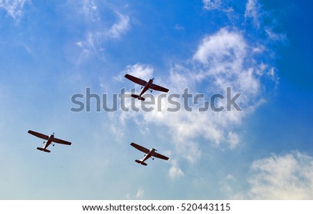 Group of old piston planes flying in formation.