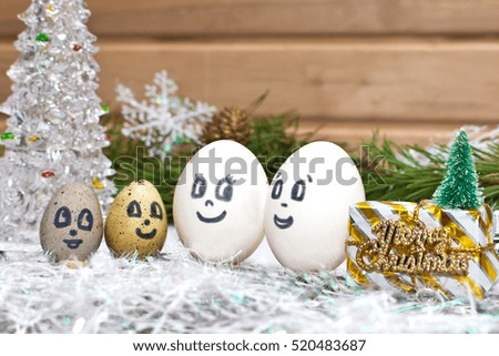 Mom dad and the kids on Christmas . Unusual eggs with faces . A Christmas cartoon.