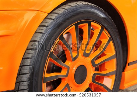 Car wheels close up.  Tuning. Orange luxury car. Supercar. Orange. England. Tuning. Karbon. Europe. Car tires. Car wheel close-up. for advertising (for advertising).
