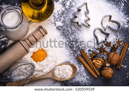 Christmas cookies. Ingredients for baking: dough, flour, forms for biscuits on wooden background