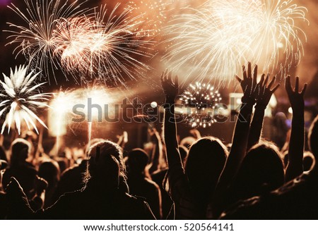 cheering crowd watching fireworks at New Year - holiday celebration background Royalty-Free Stock Photo #520564141