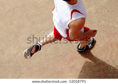 Photo of male in sportswear running down stadium track