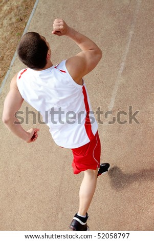 Photo of active sportsman running at stadium