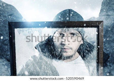 mountain hiker at snowy landscape in icy picture frame