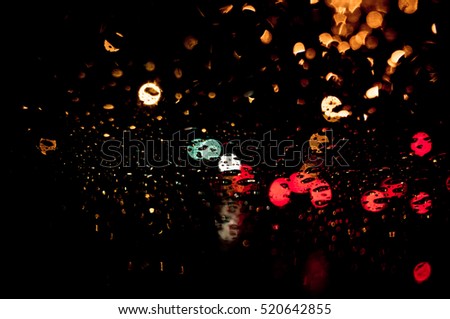 High resolution Abstract glowing rain drops blurred background in dark vivid red, green, yellow, blue