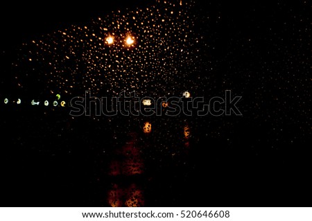 High resolution Abstract glowing rain drops blurred background in dark vivid red, yellow, blue