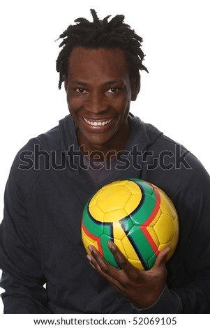 Happy young African man with a yellow soccer ball
