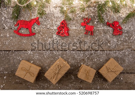 christmas lights and decorations with snow on the wooden background