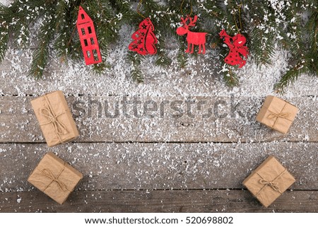 christmas tree and decorations with snow on the wooden background