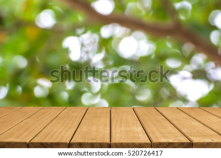 Empty top wooden table and blurred green nature bokeh background