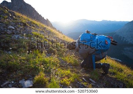 Young man taking picture at sunrise in nature