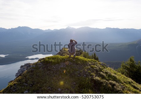 Young man taking picture at sunrise in nature