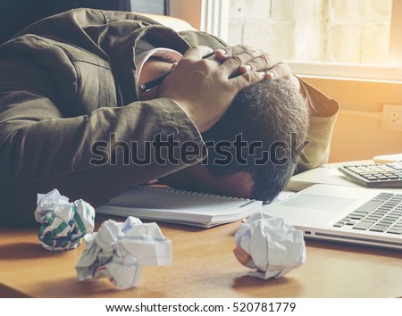 businessman failing and serious in office. Royalty-Free Stock Photo #520781779